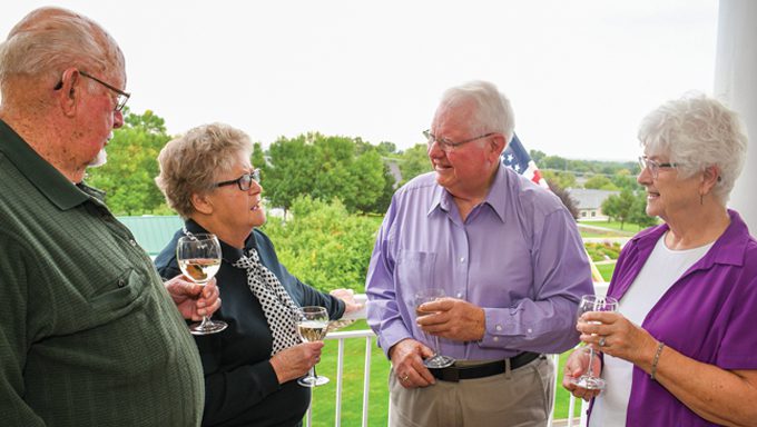 Mission Ridge Senior Living Community residents enjoying a drink on the balcony